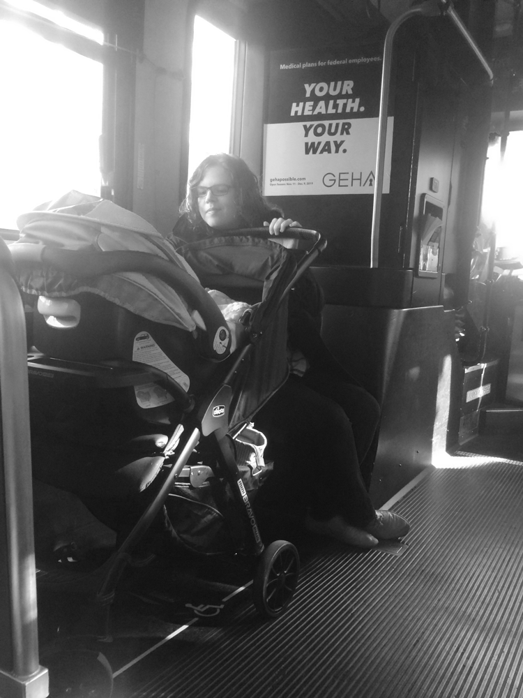 Woman on bus with baby in stroller